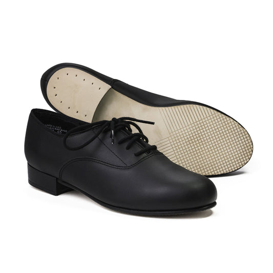 Shim Sham Oxford men’s character shoe in black leather, lace-up oxford styling, cushioned suede sock liner, leather sole with leather heel lift—modeled in performance pose
