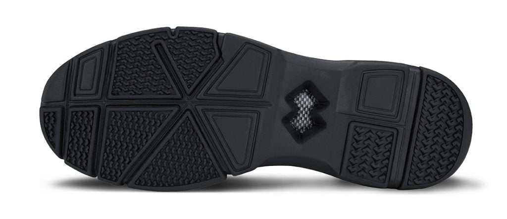 Underside view of Crossover shoe showing non-marking rubber sole with segmented grip zones and flex grooves, offering traction on turf and gym floors.