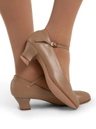 Mia Jr 1.5″ caramel character shoe featuring PU microfiber upper, sculpted heel, adjustable strap, and leather sole shown on model