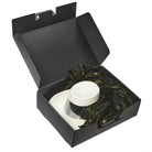 Clear cylindrical PlastiPak Aussie hat box with black base and lid, featuring molded interior supports and sturdy clip-lock closure—ideal for packing and protecting wide-brimmed hats.