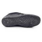 Sole view of Dinkles Spin showing smooth rubber split‑sole with pivot circle and segmented flex grooves for fluid spins and high-impact performance.