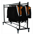 Detail of red-coated notched hanging bar on Jarvis mover with uniforms draped on hangers and tension spring securing garments—showcasing storage functionality